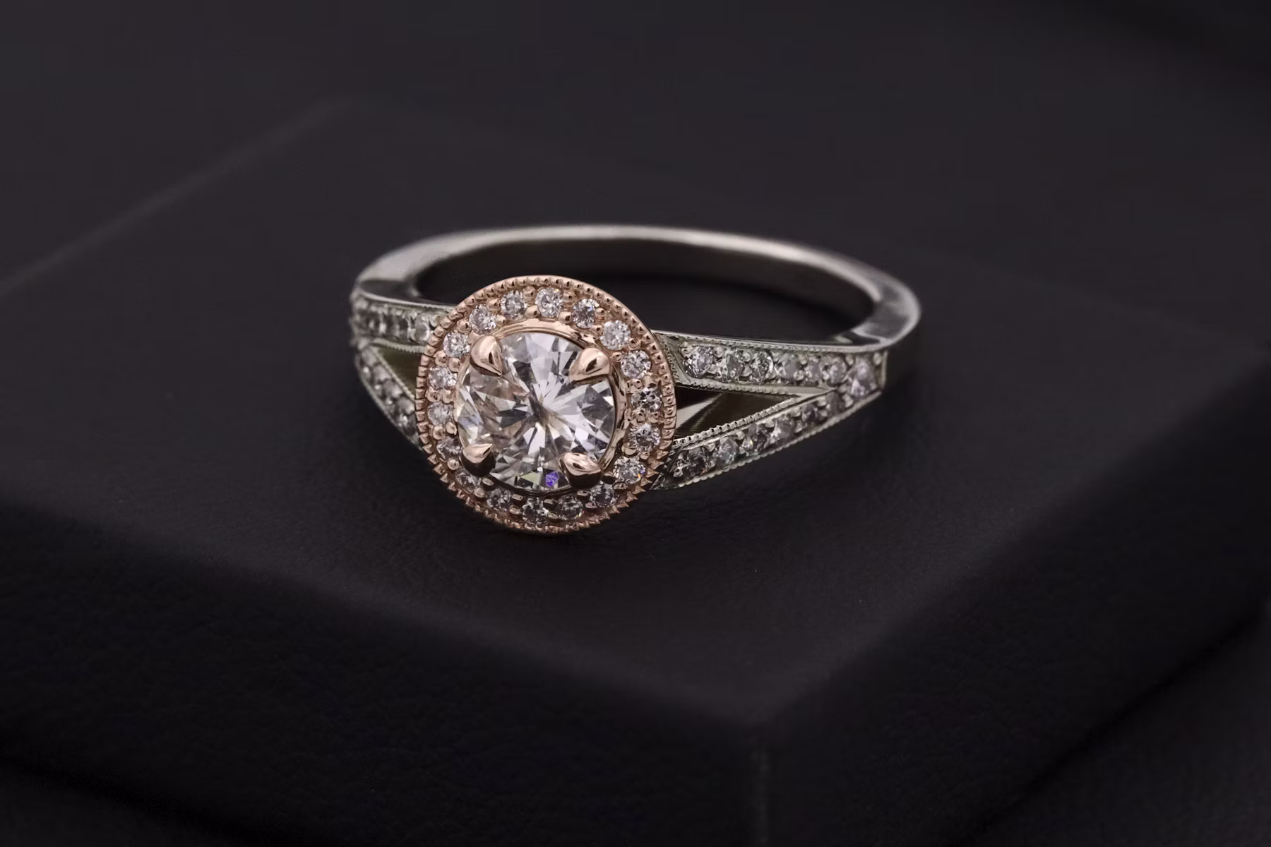 Diamond wedding rings resting on soft cream fabric